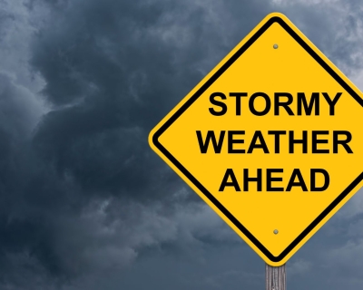 A yellow sign that says Stormy Weather Ahead