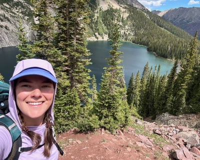 Selfie of a young woman in front of a lake