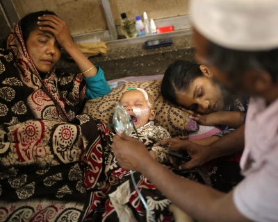 A baby who is suffering from respiratory disease receives treatment inside at Dhaka Shishu Hospital in Dhaka, Bangladesh, February 24, 2021. Syed Mahamudur Rahman/NurPhoto via Getty Images.