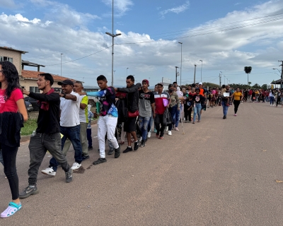 Venezuelan refugees walk after crossing the border between Venezuela and Brazil in the city of Pacaraima, Roraima State, Brazil, on September 13, 2024. 
