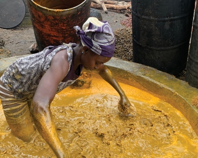 A woman at Akinlapa oil farm filters the fresh palm fruits. Abiodun Jamiu