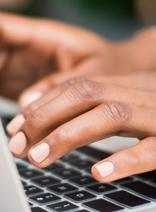 person typing on laptop