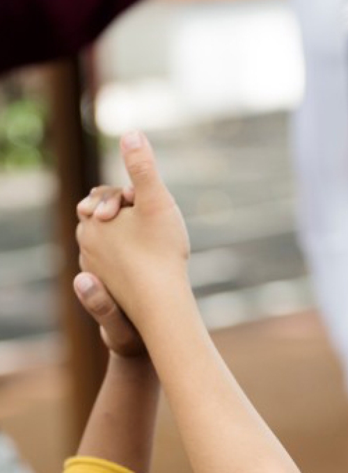 diverse group of happy children standing in a circle holding hands