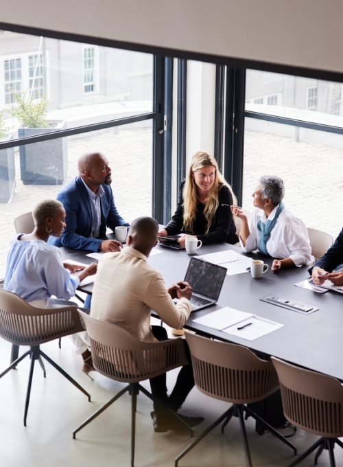 Business people sitting around a table talking