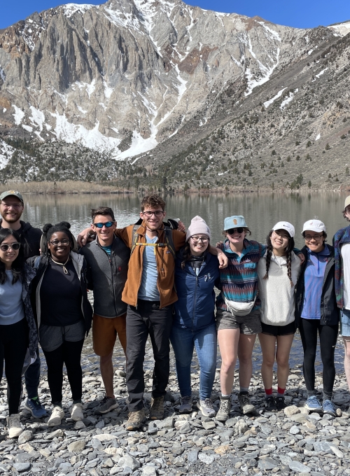 group photo of people with mountain in the background