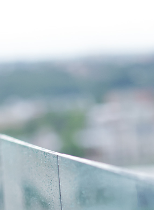 Smiling man standing outside on balcony 