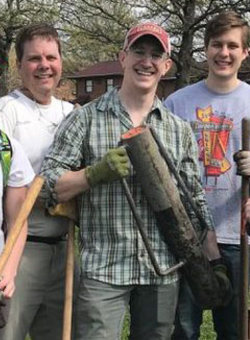 Group of people posing during a tree planting event