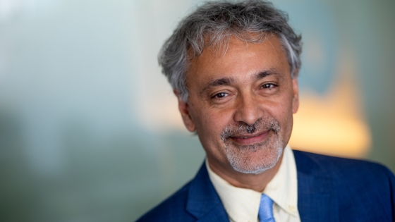 Headshot of Rajiv Rimal, PhD, taken against a blurred background 