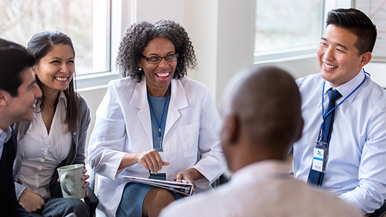 health administrators in a group laughing and smiling