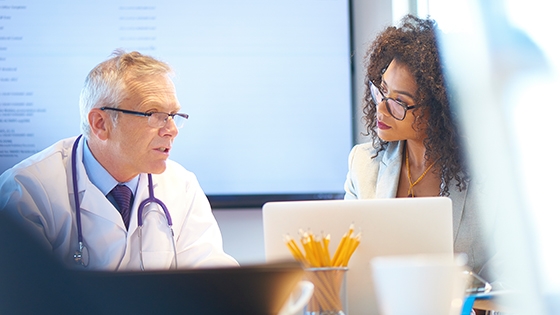 two people sitting, working together