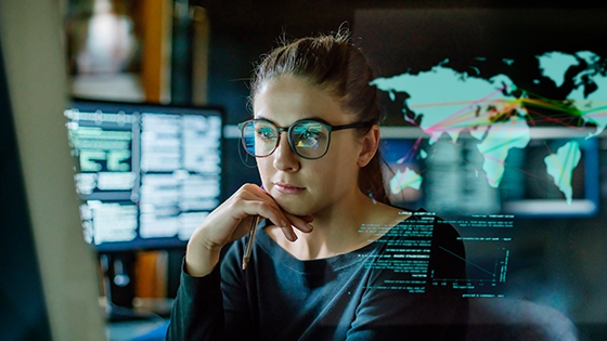 woman looking at computer screens