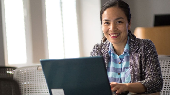 woman smiling with working on laptop computer