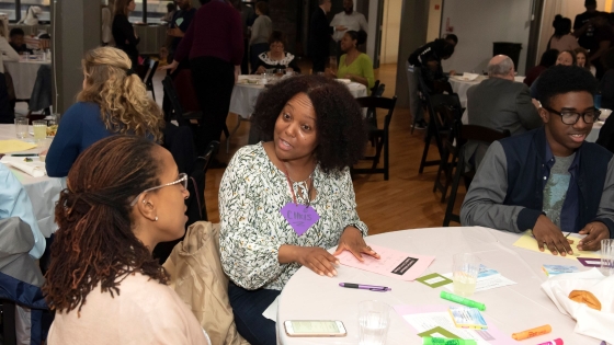 CAB member Christine Johnson talks with community member at CAH dinner