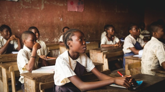 Young African students sitting at desks in a classroom