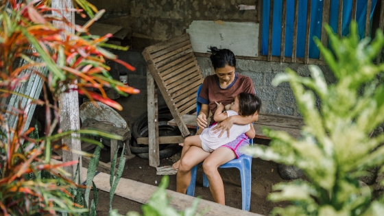 Woman breastfeeding a young child in Indonesia.
