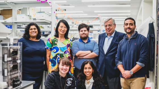 Faculty and students pose for photo in lab