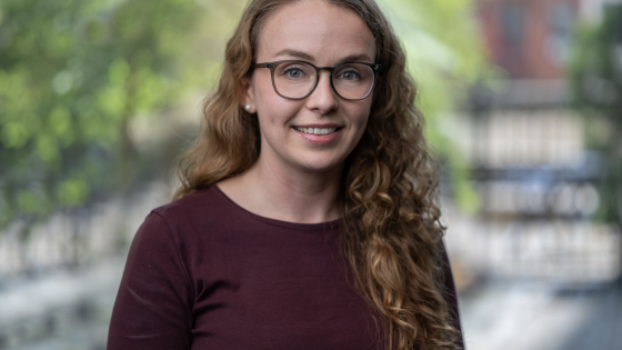 image of Anya O'Neal in crimson sweater with blurred background