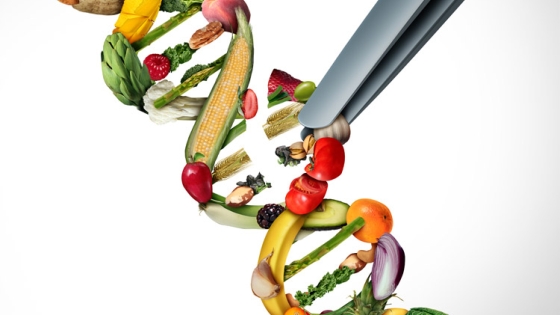 Colorful vegetables form into a DNA-like double helix; tweezers are removing part of a strand