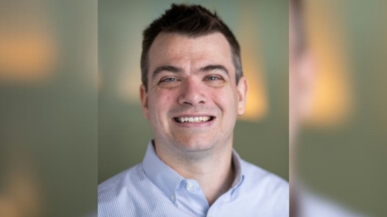 A headshot of Jeromie Ballreich, a man with a pale skin tone and short dark hair. He's wearing a collared shirt.