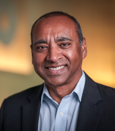 head shot of a man in a blue shirt and suit jacket