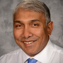 Dr. Som Saha smiles for a professional photo.