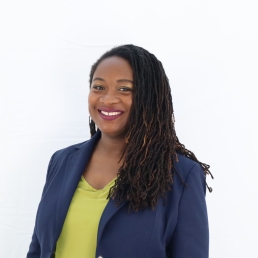 Portrait of well-dressed woman with braids smiling