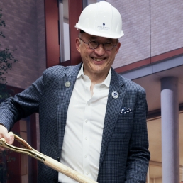 Wearing a hard hat and holding a shovel, HPM Professor Albert Wu attended the South Building groundbreaking