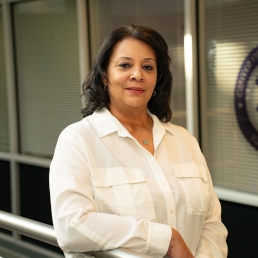 Patricia Bayton smiles for a professional photo in the 2024 E. Monument Street building.