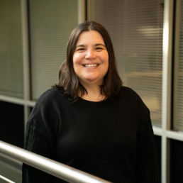 Laura Gottschalk smiles for a professional photo in the 2024 E. Monument Street building.