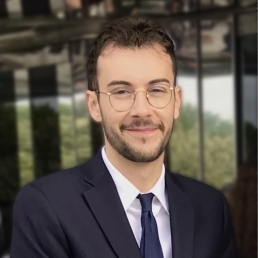 Man with glasses wearing suit and tie