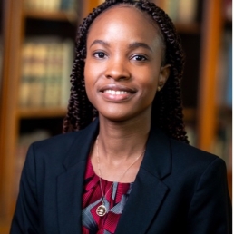 Woman in front of bookcase