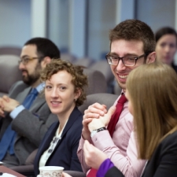 Four people sitting at a table talking with one another