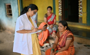 Doctor giving out prescription in rural India.