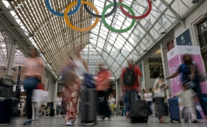 Commuters walk under the Olympic rings at the Gare de Lyon train station, on July 23, 2024, ahead of the Paris 2024 Olympic and Paralympic Games.