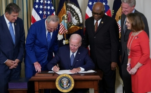 President Joe Biden signs the Inflation Reduction Act of 2022 into law during a ceremony in the State Dining Room of the White House in Washington, DC, on August 16, 2022.