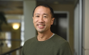 Headshot of Frank Lin, smiling in a dark green shirt.