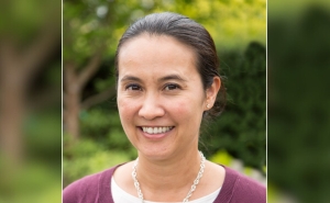A headshot of Bianca Frogner, a woman with dark-colored hair slicked back in a ponytail