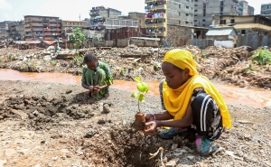 Local teenage girls resident of Kiamako slum take part in planting a tree near a site of homes destroyed by floods along the bank of Mathare river. Nairobi, Kenya, June 5, 2024. 