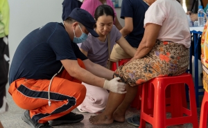 A member of China Search and Rescue Team provides medical consultations for local residents in Mandalay,  Burma (Myanmar),