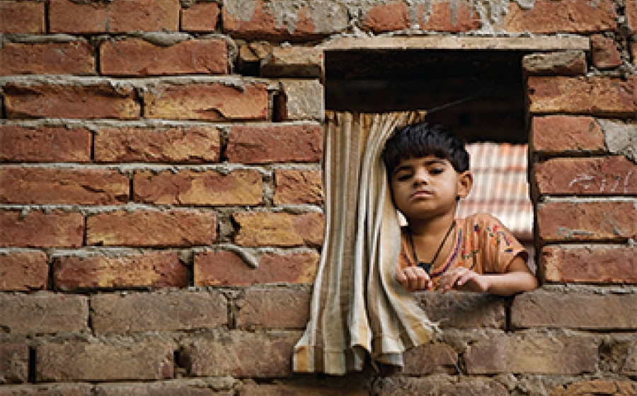 Now: Taking It Global - A boy in a brick window