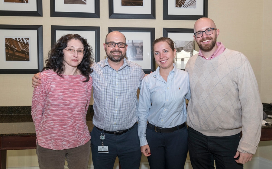 Four members of the Jordan lab stand smiling