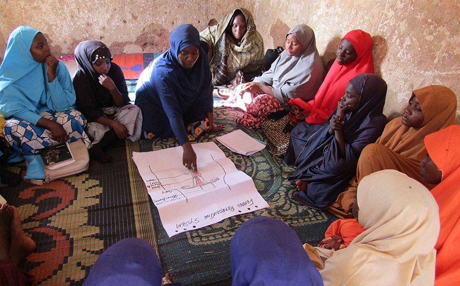 Woman teaching group of women.