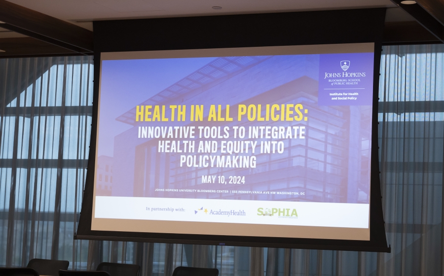 A projector screen showcasing the title Health in All Policies: Innovative Tools to Integrate Health and Equity into Policy Making.