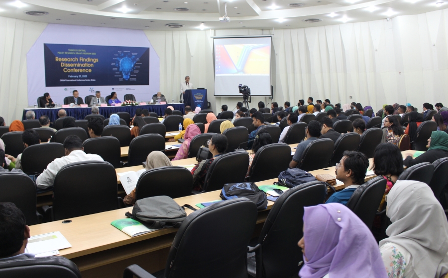 A room full of tobacco control researchers listen to a speaker at a conference.