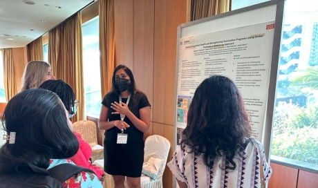 Baldeep standing next to her post, which she presents to attendees.