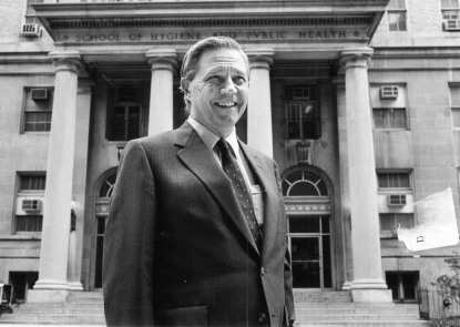 D.A.Henderson in front of Bloomberg School building