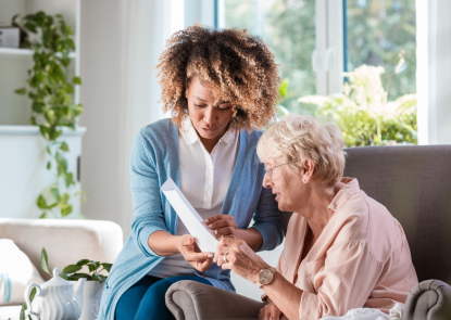 Two people reading a piece of paper