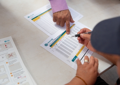 Papers and two sets of hand showing data being gathered during implementation research in Mexico.