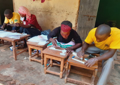 Ugandan community health workers prepare specimens for VectorCam analysis during routine mosquito surveillance