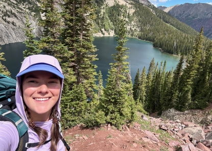 Selfie of a young woman in front of a lake